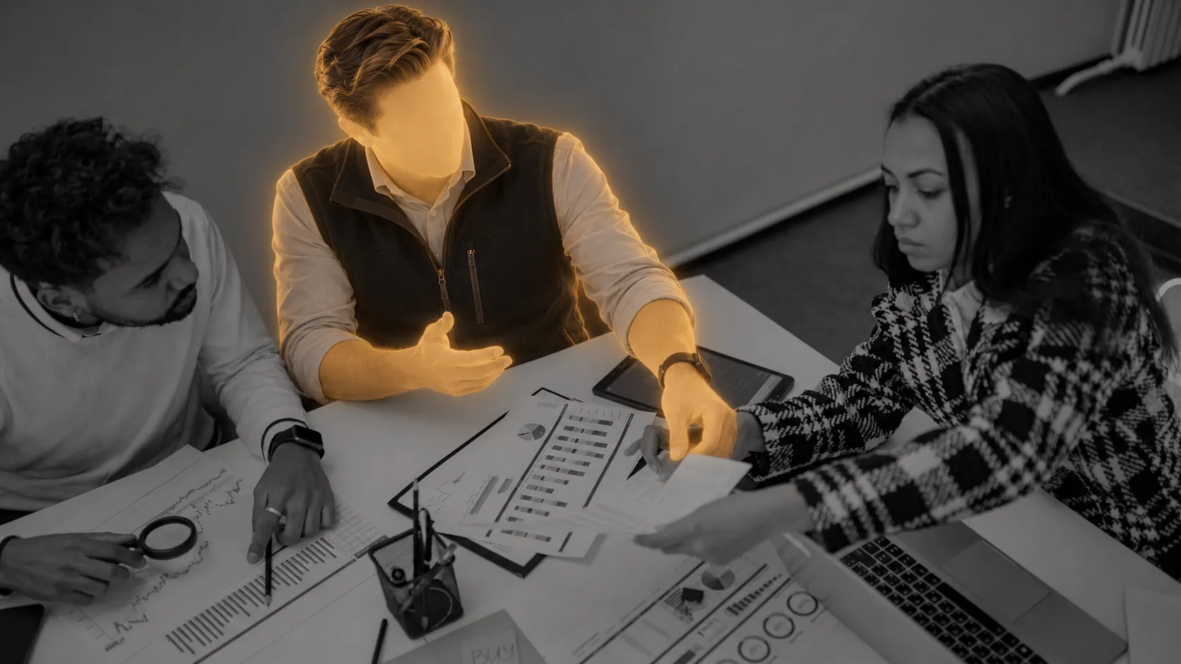 An illuminated advisor examines operating records with two colleagues at a conference table.